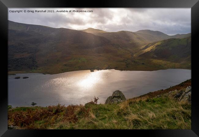 Sun breaks over icy looking Crummock Water from Rannerdale Knotts Framed Print by Greg Marshall