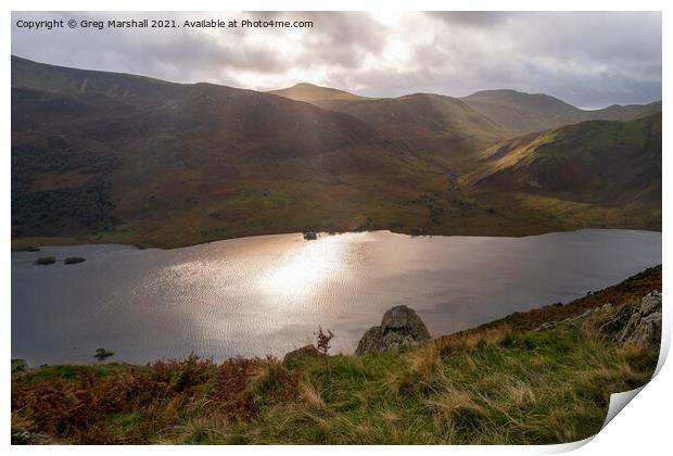 Sun breaks over icy looking Crummock Water from Rannerdale Knotts Print by Greg Marshall