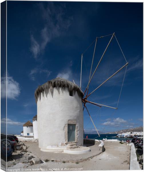 Windmills overlooking Mykonos town. Canvas Print by Chris North