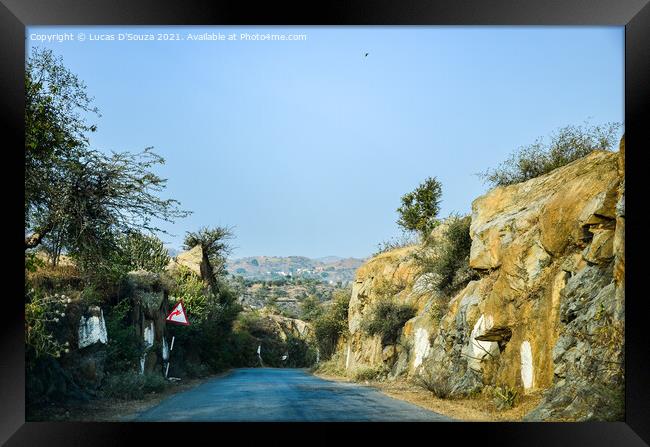 Village road through a rocky terrain Framed Print by Lucas D'Souza