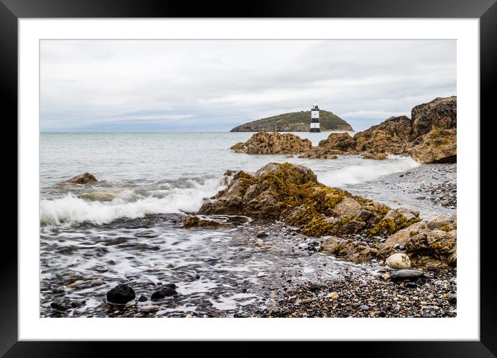 Rocks lead up to Penmon Lighthouse Framed Mounted Print by Jason Wells