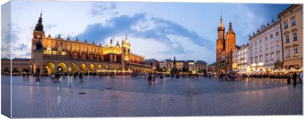 A panorama picture of Krakow`s Main Square Rynek Główny featuring the Cloth Hall, St. Mary`s Basilica and the Town Hall Tower Canvas Print by Arpan Bhatia