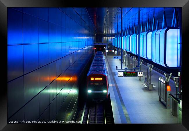 Train at the Subway station with blue lights at University on the Speicherstadt area in Hamburg Framed Print by Luis Pina