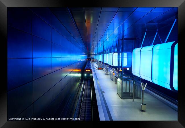 Train at the Subway station with blue lights at University on the Speicherstadt area in Hamburg Framed Print by Luis Pina
