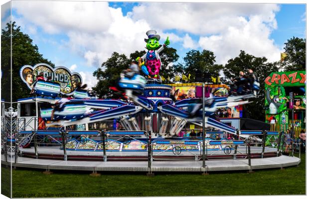 Speedy fairground ride in the WALKS, Kings Lynn. Canvas Print by Clive Wells