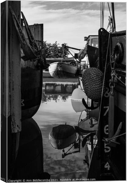 Reflections between barges in monochrome Canvas Print by Ann Biddlecombe