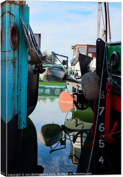 Reflections between barges Canvas Print by Ann Biddlecombe