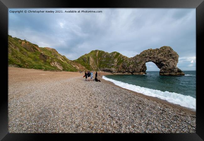 Durdle Door and tourists Framed Print by Christopher Keeley