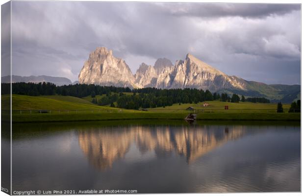 Sassolungo mountains on the Italian Alps Dolomites with water reflection on a lake Canvas Print by Luis Pina