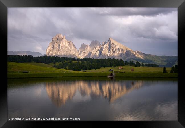 Sassolungo mountains on the Italian Alps Dolomites with water reflection on a lake Framed Print by Luis Pina