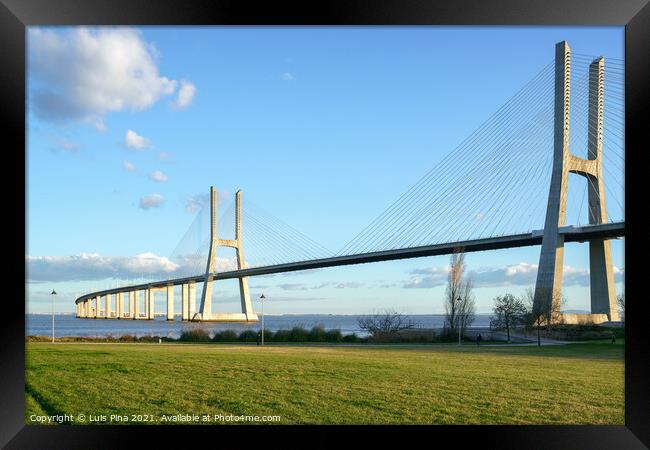 Ponte Vasco da Gama Bridge view from a garden park during the day Framed Print by Luis Pina