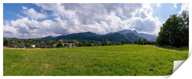 Panoramic view of green grass meadow countryside field with A shaped houses against sleeping knight tatra mountain aka as giewont and dramatic clouds located in Zakopane, South Poland, Europe Print by Arpan Bhatia