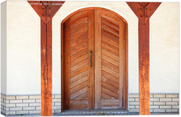 Front entrance wooden doors of a Ukrainian village hut with a massive copper handle and two symmetrical wooden supports. Canvas Print by Sergii Petruk