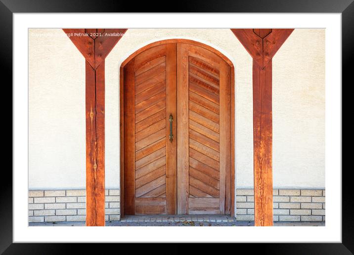 Front entrance wooden doors of a Ukrainian village hut with a massive copper handle and two symmetrical wooden supports. Framed Mounted Print by Sergii Petruk