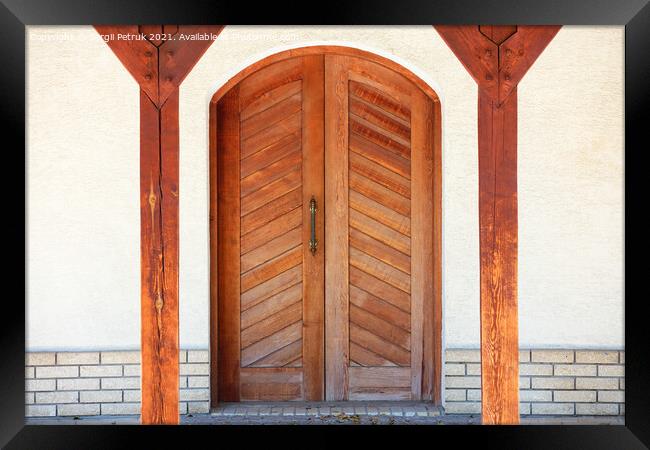 Front entrance wooden doors of a Ukrainian village hut with a massive copper handle and two symmetrical wooden supports. Framed Print by Sergii Petruk