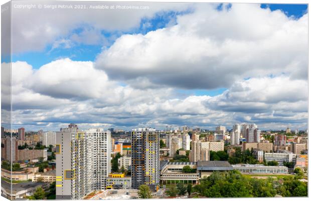 Dramatic beautiful sky with thick clouds over residential areas of the city. Canvas Print by Sergii Petruk