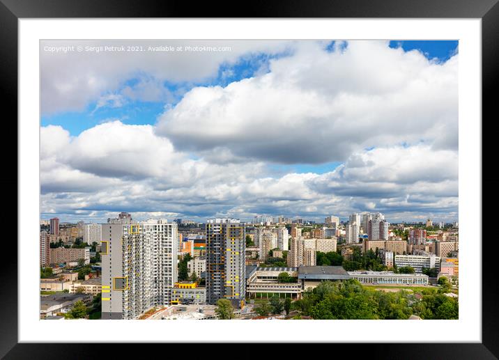Dramatic beautiful sky with thick clouds over residential areas of the city. Framed Mounted Print by Sergii Petruk