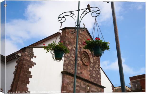 Funchal Cathedral church seen from the street with flowers hanging in Madeira Canvas Print by Luis Pina