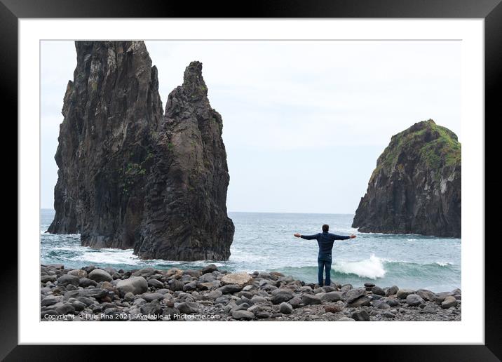 Man with arms wide open looking at Ribeira da Janela islet in Madeira Framed Mounted Print by Luis Pina