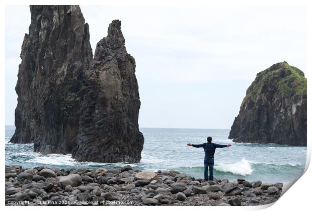 Man with arms wide open looking at Ribeira da Janela islet in Madeira Print by Luis Pina