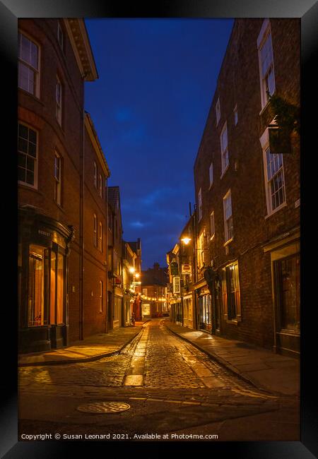 York street after night fall. Framed Print by Susan Leonard