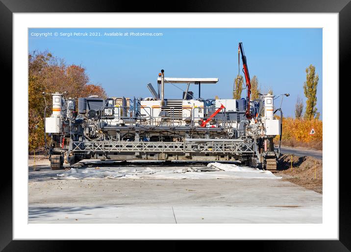 An industrial paver paves a new road on a bright, sunny autumn day. Framed Mounted Print by Sergii Petruk