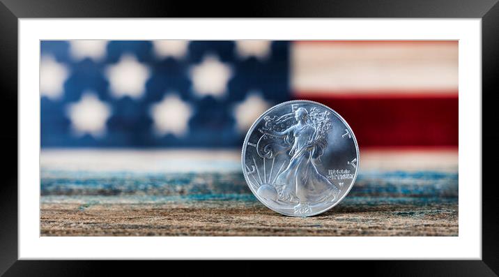 American silver eagle dollar coin with US flag in background Framed Mounted Print by Thomas Baker