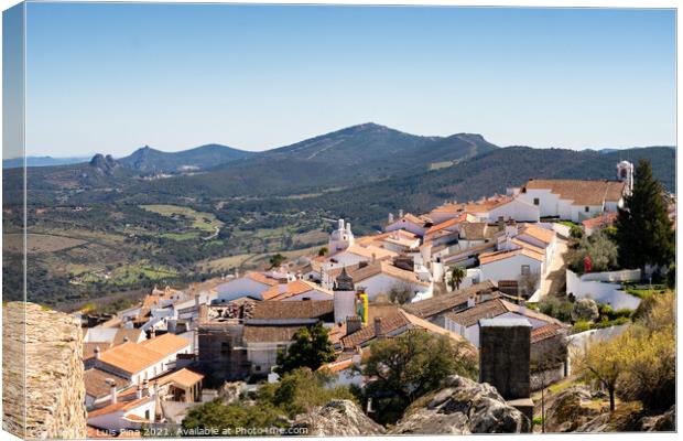 View of Marvao village with beautiful houses and church with rocky landscape mountains behind Canvas Print by Luis Pina