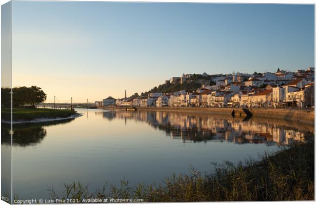 View of Alcacer do Sal cityscape from the other side of the Sado river at sunset Canvas Print by Luis Pina