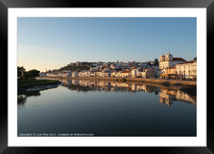 View of Alcacer do Sal cityscape from the other side of the Sado river at sunset Framed Mounted Print by Luis Pina