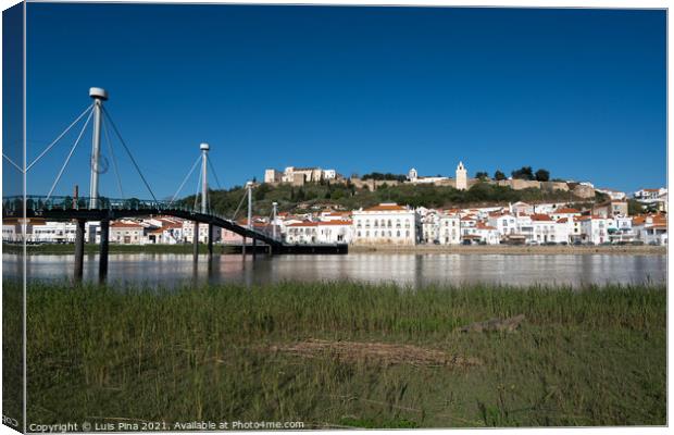 View of Alcacer do Sal cityscape from the other side of the Sado river and a bridge Canvas Print by Luis Pina