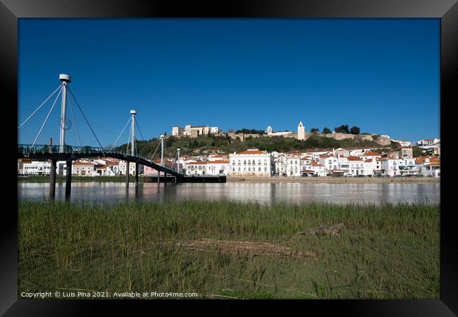 View of Alcacer do Sal cityscape from the other side of the Sado river and a bridge Framed Print by Luis Pina