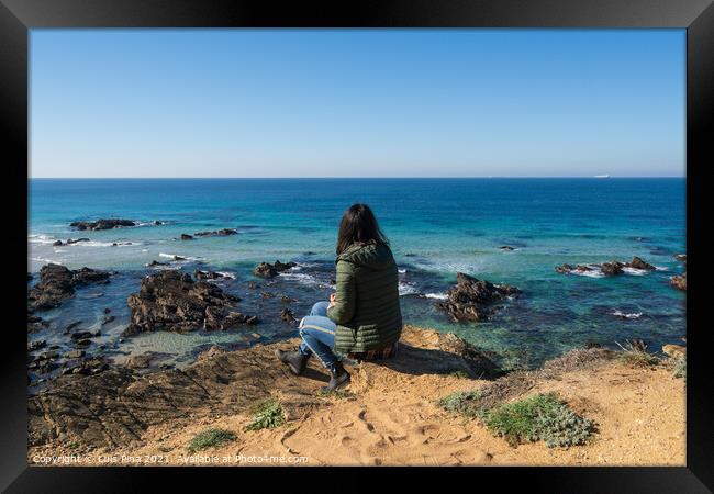 Woman looking at Praia da Samoqueira Framed Print by Luis Pina