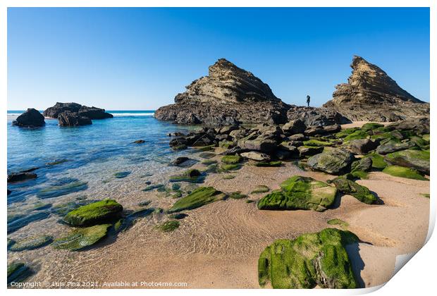 Woman on the rocks at Praia da Samoqueira beach in Portugal Print by Luis Pina