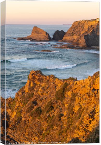 Woman on a cliff at Praia de Odeceixe in Costa Vicentina, Portugal Canvas Print by Luis Pina