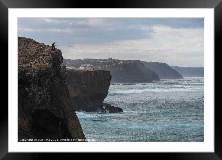 Fishermen fishing in Praia de Aljezur beach sea cliff edge, in Portugal Framed Mounted Print by Luis Pina