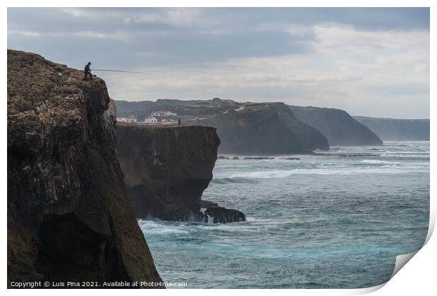 Fishermen fishing in Praia de Aljezur beach sea cliff edge, in Portugal Print by Luis Pina