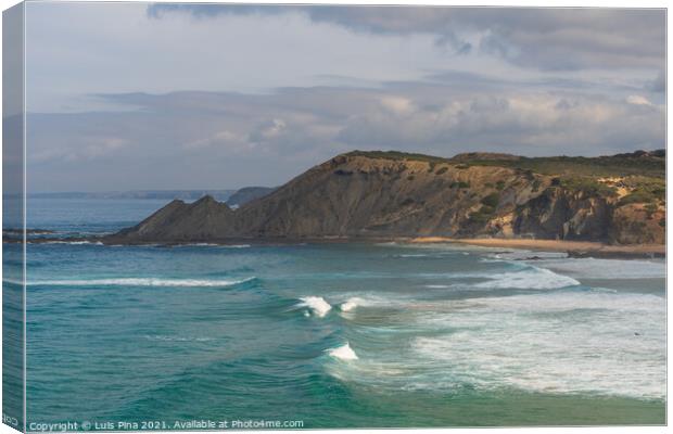 Aljezur beach with waves crashing and sea cliffs on the background Canvas Print by Luis Pina