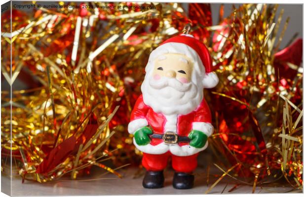 Santa Claus figurine and red and golden tinsel Canvas Print by aurélie le moigne