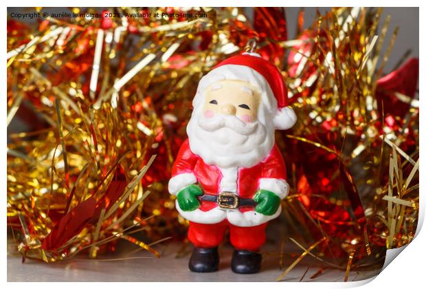 Santa Claus figurine and red and golden tinsel Print by aurélie le moigne