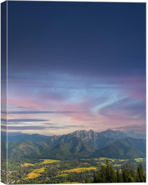 Vertical view of mountains in nature of sleeping knight tatra mountain covered with dramatic clouds aka as giewont and dramatic sunset or sunrise located in Zakopane, South Poland, Europe. Canvas Print by Arpan Bhatia