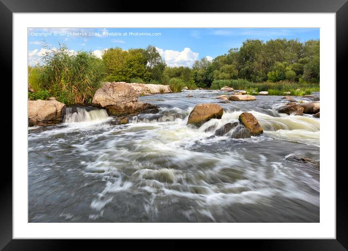 Stormy streams of water wash over the rocky banks of the river, overcoming rapids on a bright summer day. Framed Mounted Print by Sergii Petruk