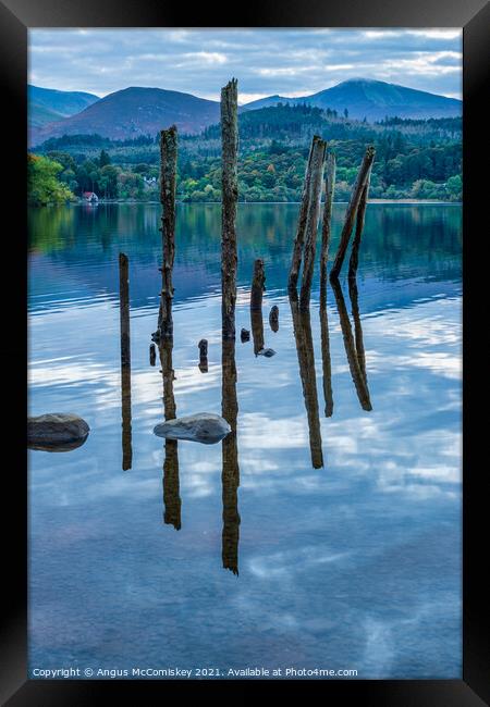 Old jetty piles on Derwentwater Framed Print by Angus McComiskey