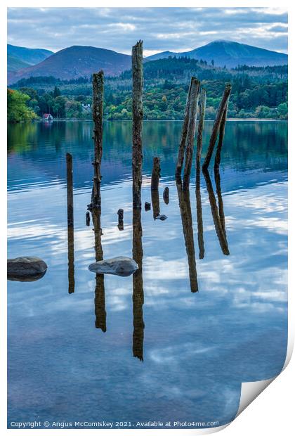 Old jetty piles on Derwentwater Print by Angus McComiskey
