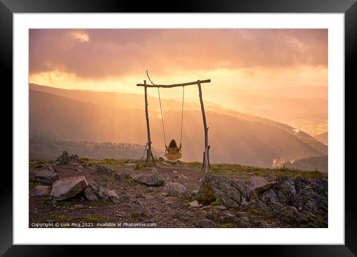Woman girl social distancing swinging on a Swing baloico in Lousa mountain, Portugal at sunset Framed Mounted Print by Luis Pina