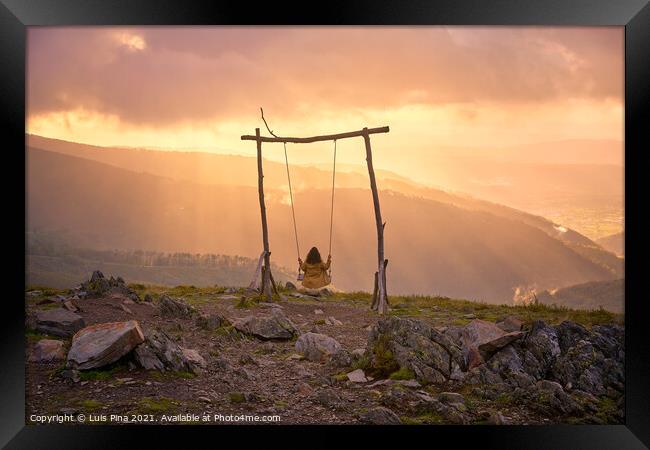 Woman girl social distancing swinging on a Swing baloico in Lousa mountain, Portugal at sunset Framed Print by Luis Pina