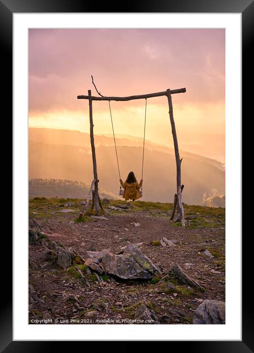 Woman girl social distancing swinging on a Swing baloico in Lousa mountain, Portugal at sunset Framed Mounted Print by Luis Pina