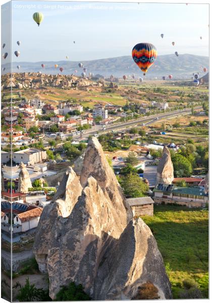 Dozens of balloons fly over the city of Goreme in Turkey and over the valleys of Cappadocia. Canvas Print by Sergii Petruk