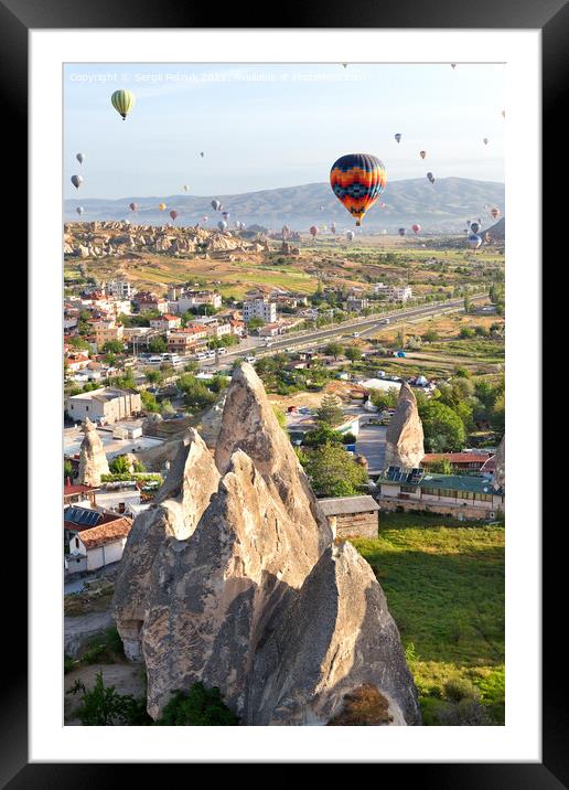 Dozens of balloons fly over the city of Goreme in Turkey and over the valleys of Cappadocia. Framed Mounted Print by Sergii Petruk