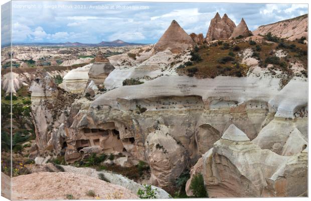 Ancient caves in the rocky mountain ranges of Cappadocia, an unusual landscape of central Turkey. Canvas Print by Sergii Petruk